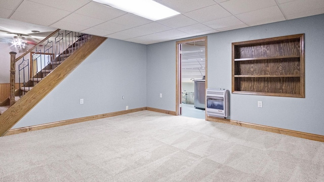 108 Viking Dr, Colfax, WI 54730 - unfurnished living room featuring heating unit, carpet, a drop ceiling, stairs, and built in features