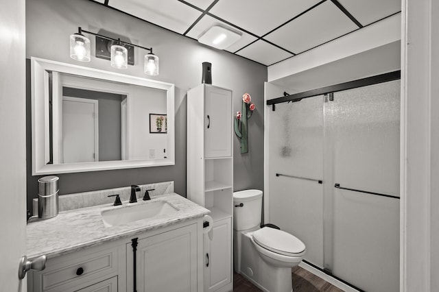 400 1st St Unit 611, Minneapolis, MN 55401 - bathroom featuring a stall shower, vanity, and wood finished floors