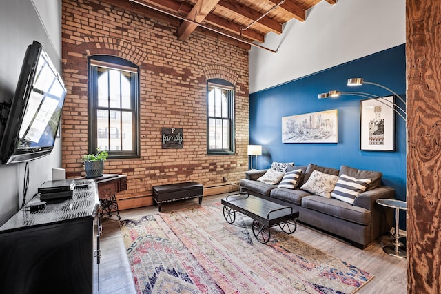 400 1st St Unit 611, Minneapolis, MN 55401 - living area with a wooden ceiling with exposed beams, brick wall, wood finished floors, and a high ceiling