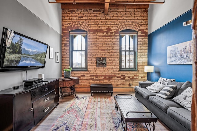 400 1st St Unit 611, Minneapolis, MN 55401 - living room featuring brick wall, a towering ceiling, plenty of natural light, wood finished floors, and beamed ceiling