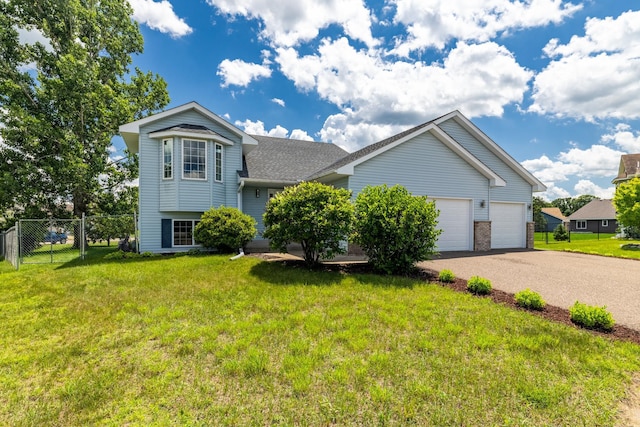 24155 Whispering Cir, East Bethel, MN 55005 - split level home featuring asphalt driveway, an attached garage, and a shingled roof