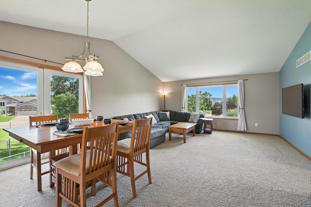 24155 Whispering Cir, East Bethel, MN 55005 - dining space featuring lofted ceiling, light carpet, and a chandelier