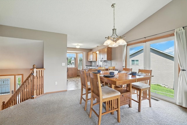 24155 Whispering Cir, East Bethel, MN 55005 - dining room featuring light colored carpet, a chandelier, and lofted ceiling