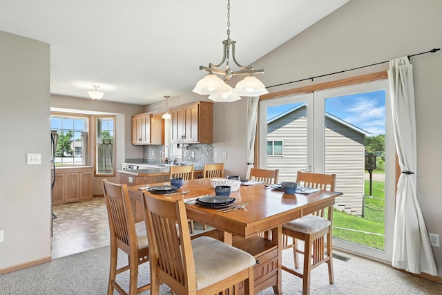 24155 Whispering Cir, East Bethel, MN 55005 - dining space featuring light colored carpet and a chandelier