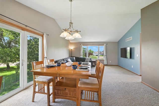 24155 Whispering Cir, East Bethel, MN 55005 - dining room featuring lofted ceiling, light colored carpet, and a chandelier