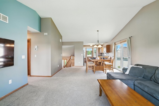 24155 Whispering Cir, East Bethel, MN 55005 - living area with light colored carpet, high vaulted ceiling, and a chandelier