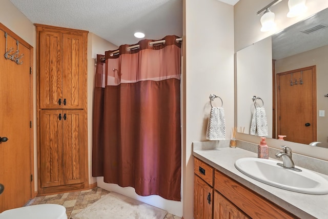 24155 Whispering Cir, East Bethel, MN 55005 - bathroom featuring vanity, shower / bathtub combination with curtain, and a textured ceiling