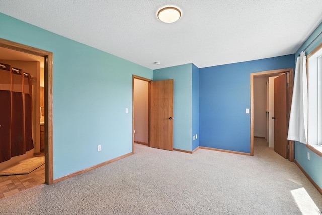 24155 Whispering Cir, East Bethel, MN 55005 - unfurnished bedroom featuring carpet, a textured ceiling, and ensuite bath