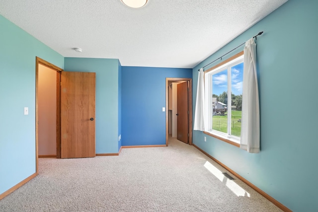 24155 Whispering Cir, East Bethel, MN 55005 - unfurnished bedroom with a textured ceiling and carpet