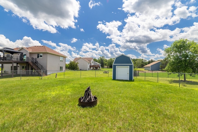 24155 Whispering Cir, East Bethel, MN 55005 - fenced backyard featuring a storage shed, stairway, a fire pit, and a wooden deck