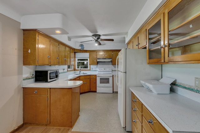 11965 State Highway 15, Kimball, MN 55353 - kitchen with white appliances, brown cabinetry, light countertops, a peninsula, and a ceiling fan