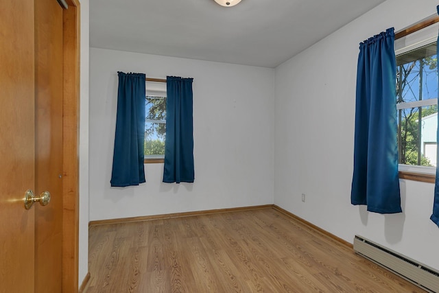 11965 State Highway 15, Kimball, MN 55353 - empty room with a baseboard heating unit and wood finished floors