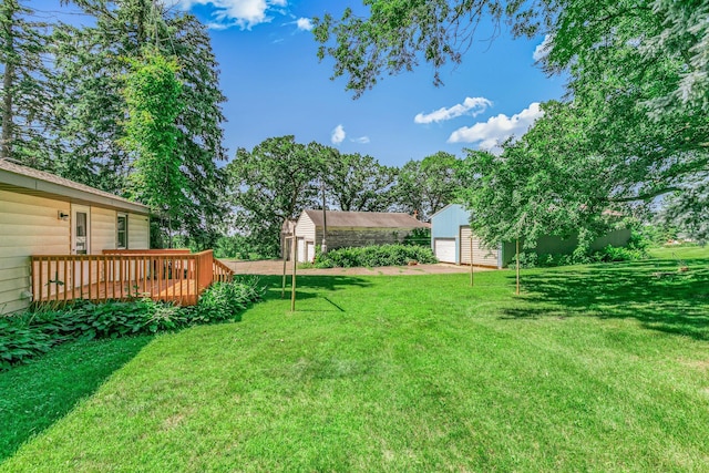 11965 State Highway 15, Kimball, MN 55353 - view of grassy yard with a deck, an outdoor structure, and a garage