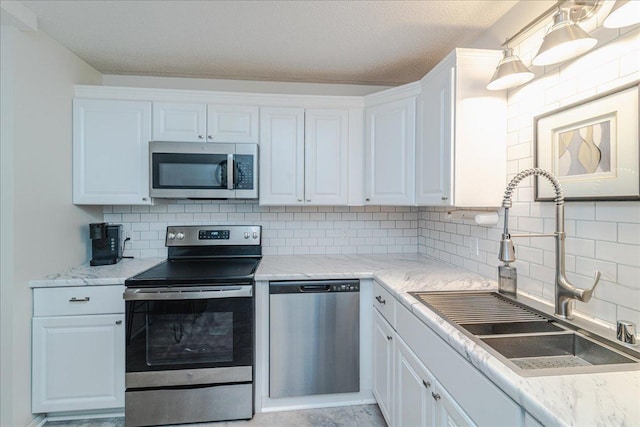 2601 Kenzie Ter Unit 519, Saint Anthony, MN 55418 - kitchen featuring stainless steel appliances, backsplash, white cabinets, a textured ceiling, and light stone countertops