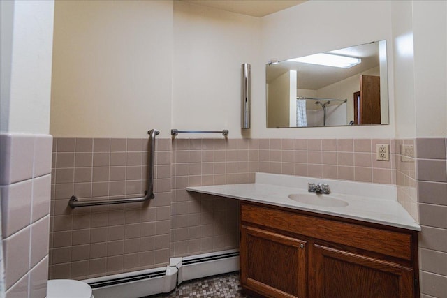 2601 Kenzie Ter Unit 519, Saint Anthony, MN 55418 - bathroom with tile walls, vanity, a baseboard radiator, and wainscoting
