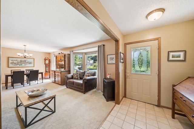 901 Grandview Dr, Hudson, WI 54016 - entrance foyer featuring a textured ceiling, a chandelier, light colored carpet, and light tile patterned flooring