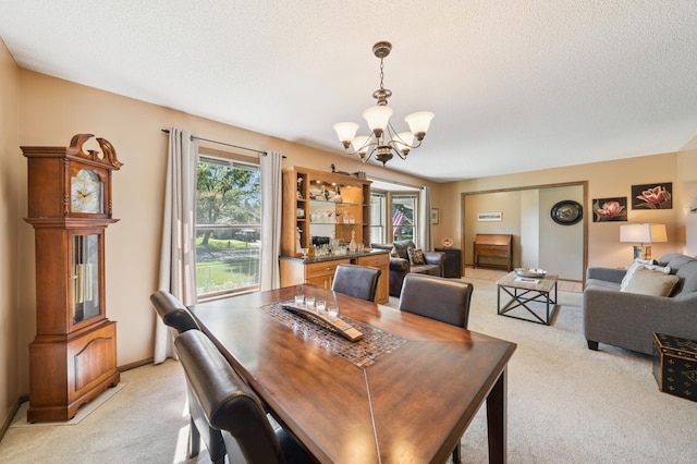 901 Grandview Dr, Hudson, WI 54016 - dining room featuring light carpet, a chandelier, and a textured ceiling