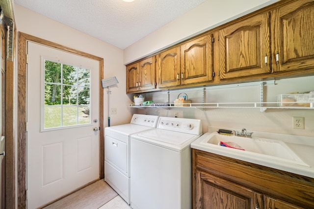 901 Grandview Dr, Hudson, WI 54016 - laundry room with cabinet space, washing machine and dryer, and a textured ceiling