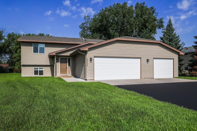 13752 Round Lake Blvd NW, Andover, MN 55304 - split level home with an attached garage, driveway, and a front lawn
