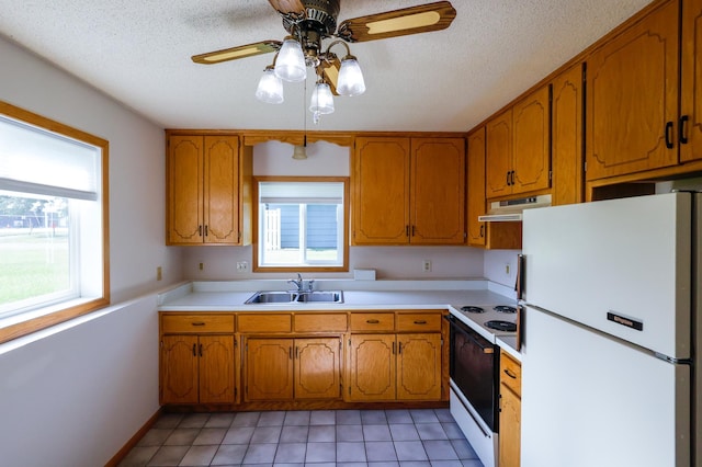 13752 Round Lake Blvd NW, Andover, MN 55304 - kitchen featuring freestanding refrigerator, range with electric stovetop, ventilation hood, plenty of natural light, and a textured ceiling