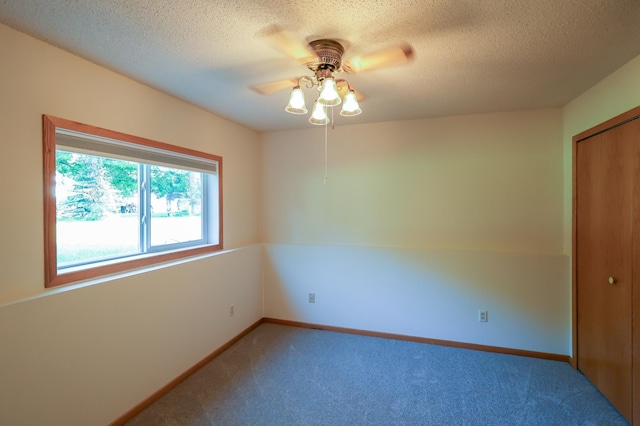13752 Round Lake Blvd NW, Andover, MN 55304 - unfurnished room with light carpet, a ceiling fan, and a textured ceiling