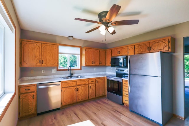 13752 Round Lake Blvd NW, Andover, MN 55304 - kitchen featuring stainless steel appliances, light countertops, and brown cabinets