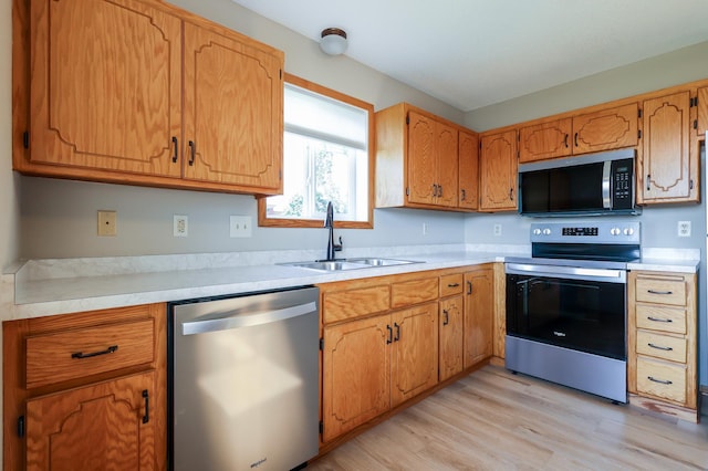 13752 Round Lake Blvd NW, Andover, MN 55304 - kitchen with appliances with stainless steel finishes, light wood finished floors, light countertops, and brown cabinets
