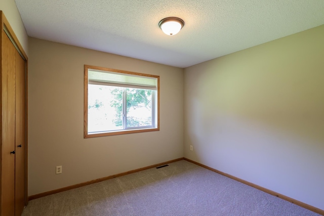 13752 Round Lake Blvd NW, Andover, MN 55304 - carpeted spare room with a textured ceiling and baseboards