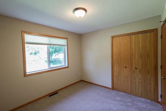 13752 Round Lake Blvd NW, Andover, MN 55304 - unfurnished bedroom featuring a closet, carpet floors, and a textured ceiling