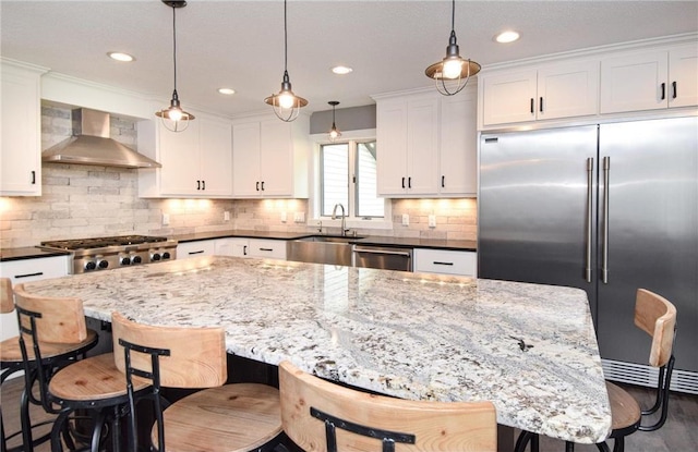 10200 Kadler Ave NE, Otsego, MN 55362 - kitchen with wall chimney exhaust hood, stainless steel appliances, white cabinetry, light stone countertops, and tasteful backsplash