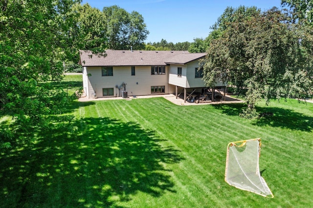 10200 Kadler Ave NE, Otsego, MN 55362 - rear view of house with a patio area, a yard, and view of wooded area