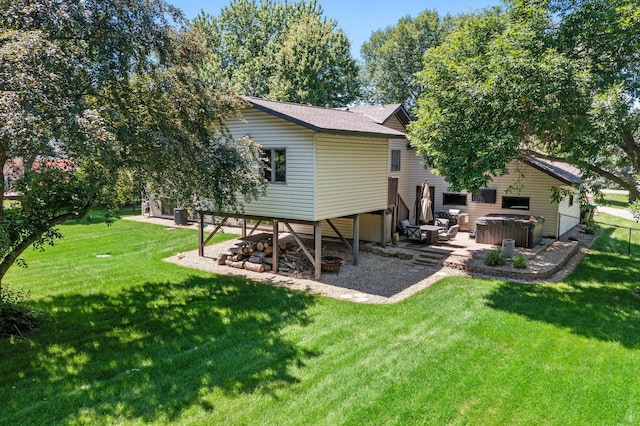 10200 Kadler Ave NE, Otsego, MN 55362 - rear view of property featuring a hot tub, a lawn, and a patio area