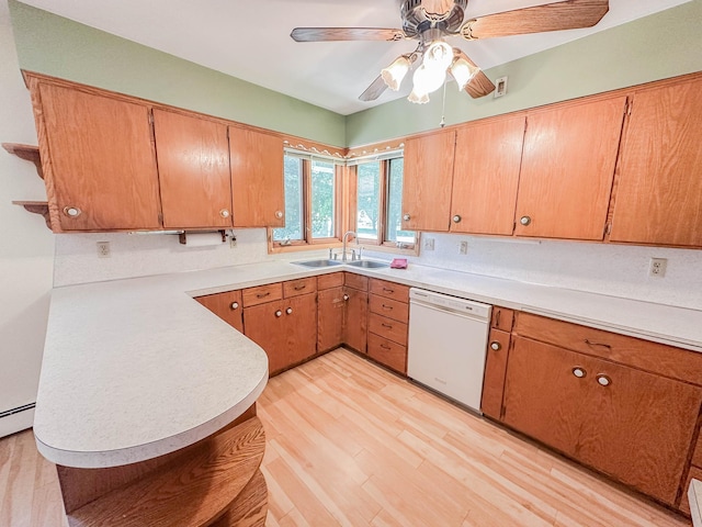 540 8th St, Bird Island, MN 55310 - kitchen with white dishwasher, light wood finished floors, light countertops, a ceiling fan, and brown cabinetry
