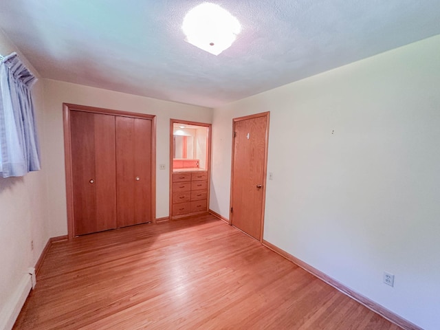540 8th St, Bird Island, MN 55310 - unfurnished bedroom with light wood-type flooring and a closet