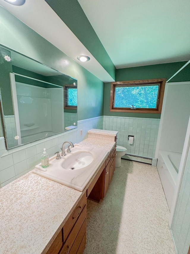 540 8th St, Bird Island, MN 55310 - bathroom featuring tile walls, vanity, a baseboard radiator, shower / tub combination, and wainscoting