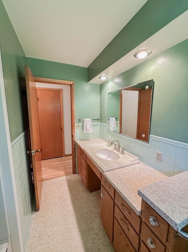 540 8th St, Bird Island, MN 55310 - bathroom with tile walls, vanity, and wainscoting