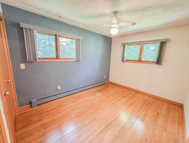 540 8th St, Bird Island, MN 55310 - empty room featuring a baseboard radiator, wood finished floors, and a ceiling fan