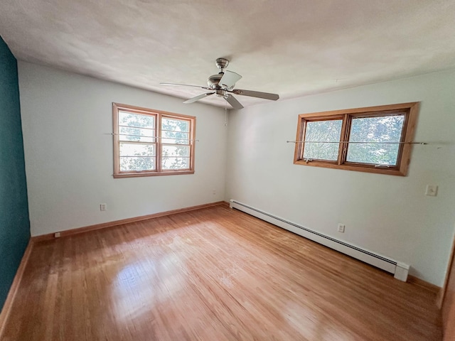 540 8th St, Bird Island, MN 55310 - spare room with a baseboard heating unit, healthy amount of natural light, light wood-type flooring, and ceiling fan