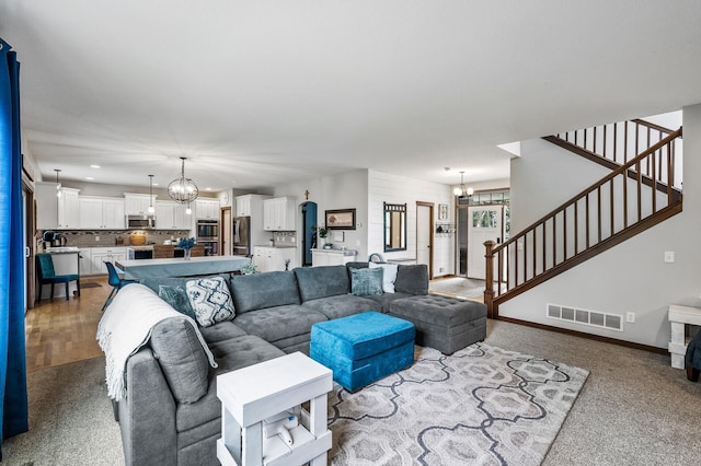 1799 158th Ln NW, Andover, MN 55304 - carpeted living room with a chandelier, stairs, and recessed lighting