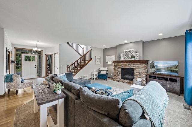 1799 158th Ln NW, Andover, MN 55304 - living room with a chandelier, stairway, a fireplace, recessed lighting, and light wood-style floors