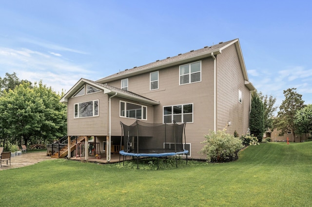 1799 158th Ln NW, Andover, MN 55304 - rear view of property featuring a patio, stairway, a yard, and a trampoline