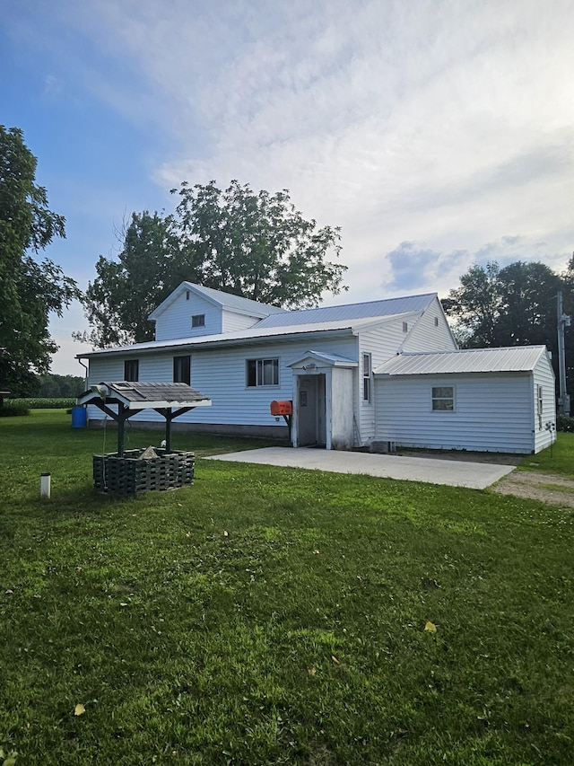 15596 464th St, Hewitt, MN 56453 - view of front of home with a patio, a front yard, and a metal roof