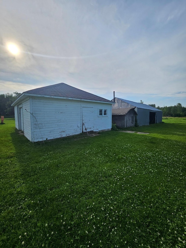 15596 464th St, Hewitt, MN 56453 - view of home's exterior with a yard, an outdoor structure, and an outbuilding