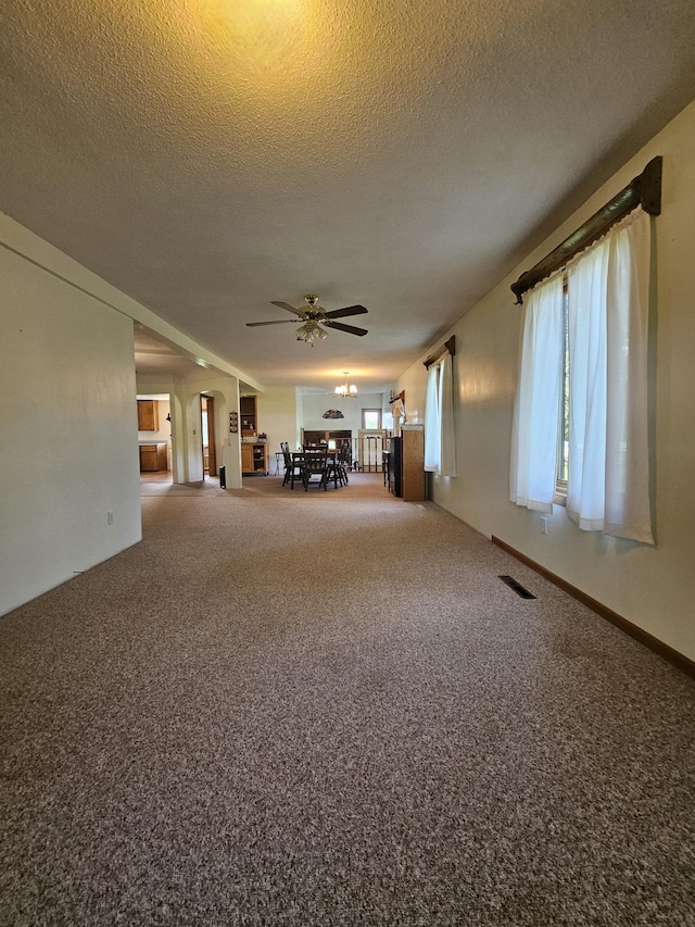 15596 464th St, Hewitt, MN 56453 - unfurnished living room with a ceiling fan, carpet floors, and a textured ceiling