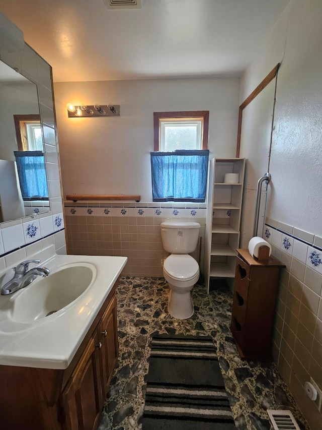 15596 464th St, Hewitt, MN 56453 - bathroom featuring tile walls, vanity, and a wainscoted wall