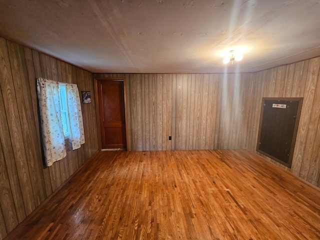 15596 464th St, Hewitt, MN 56453 - spare room featuring wood finished floors and wood walls