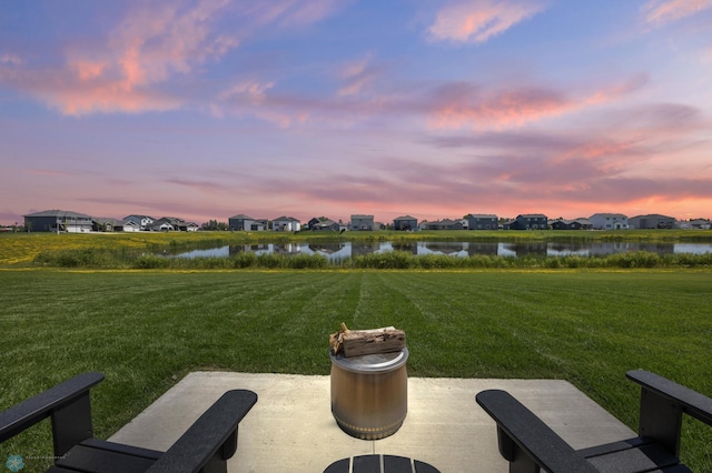 10128 Concord Dr, Horace, ND 58047 - view of grassy yard featuring a water view, a residential view, and a patio