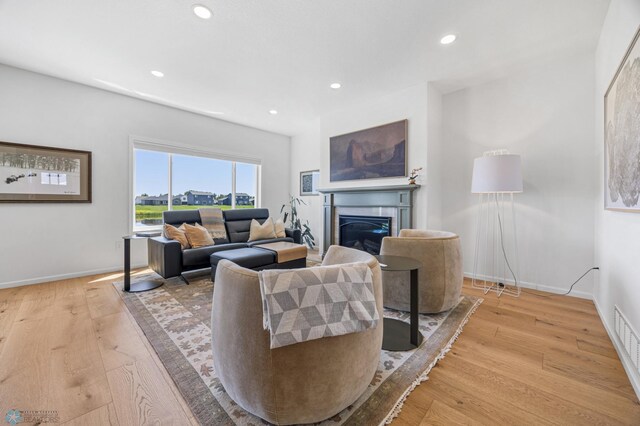 10128 Concord Dr, Horace, ND 58047 - living area featuring a glass covered fireplace, recessed lighting, and light wood-style floors
