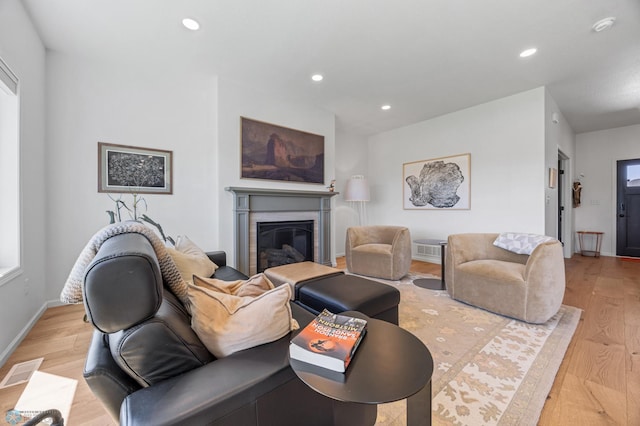 10128 Concord Dr, Horace, ND 58047 - living room with light wood-style flooring, recessed lighting, and a glass covered fireplace