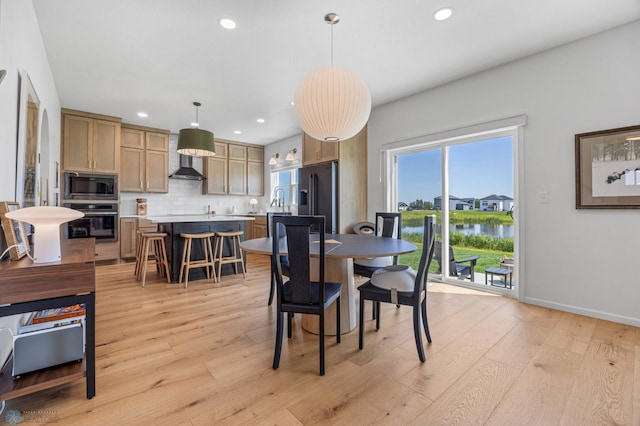 10128 Concord Dr, Horace, ND 58047 - dining area featuring a water view, recessed lighting, and light wood-type flooring